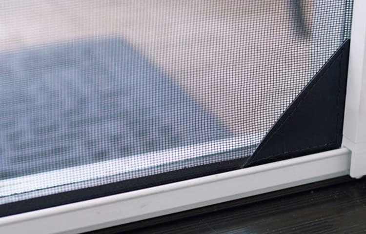 Reinforced corner of screen mesh showing black edge detail