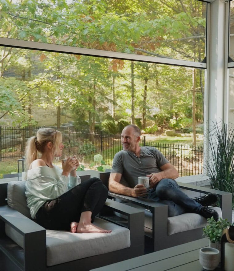 a photo of athlete Mike Weaver and his partner sitting on a screened-in patio