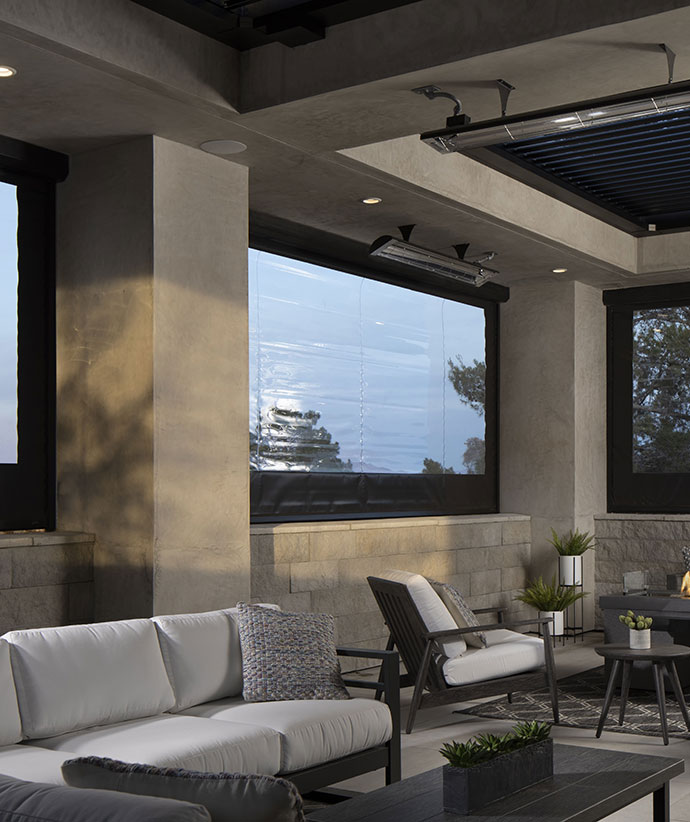 Luxury indoor-outdoor space with retractable screens offering panoramic views and modern lounge seating