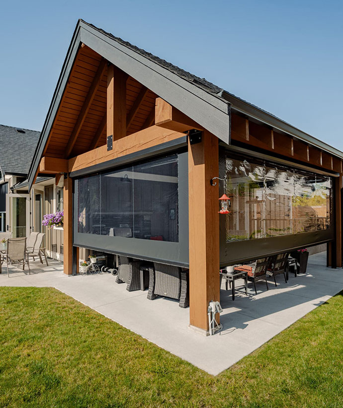 Modern covered patio with retractable screens featuring wood ceiling and contemporary outdoor furniture