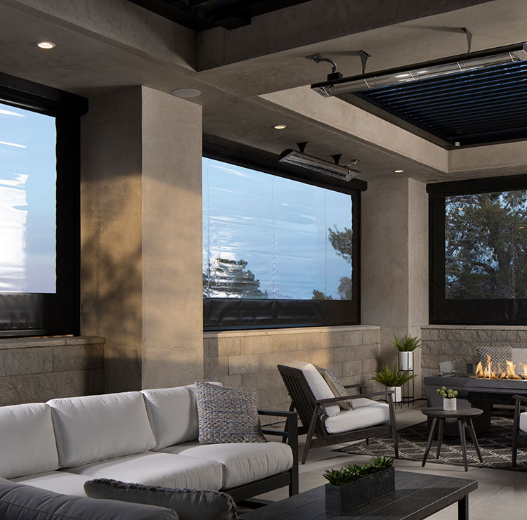 Modern covered patio with luxury vinyl screens, featuring contemporary lounge furniture and linear gas fireplace