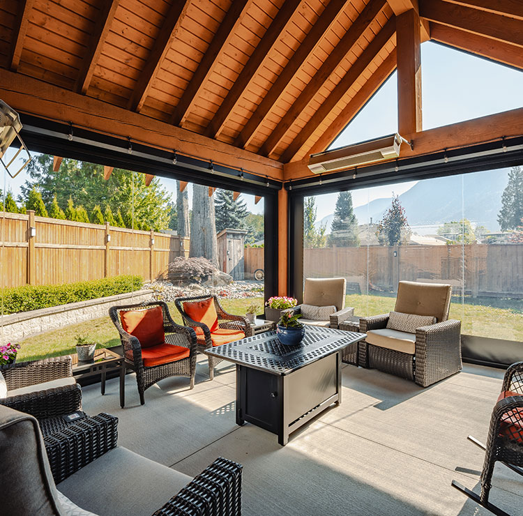 Cozy screened patio with outdoor seating, protected by clear vinyl panels with mountain views