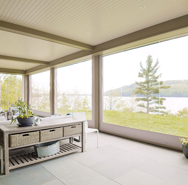 Luxury vinyl screens enclosing lakeside porch with dining area and expansive water views