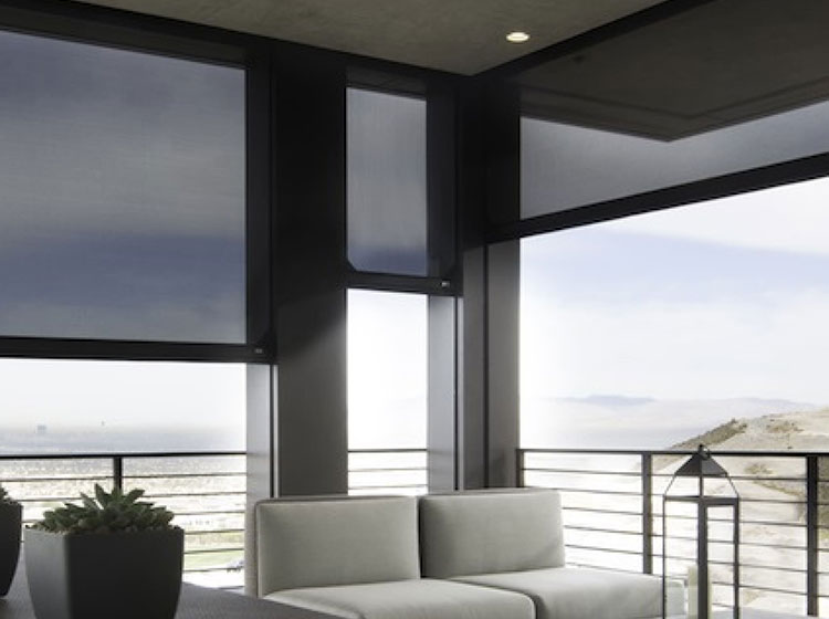 Modern balcony with motorized screens and cable railing overlooking mountain landscape
