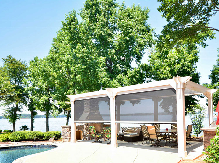 Lakeside pergola with retractable screens, outdoor seating area and pool