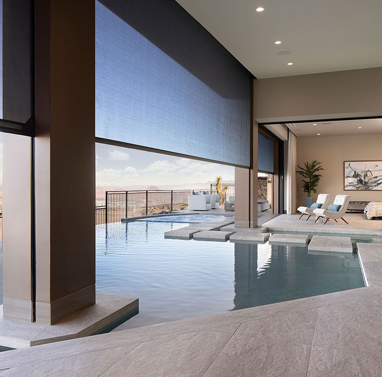 Desert home with infinity pool and motorized screens, featuring mountain vista and modern interior