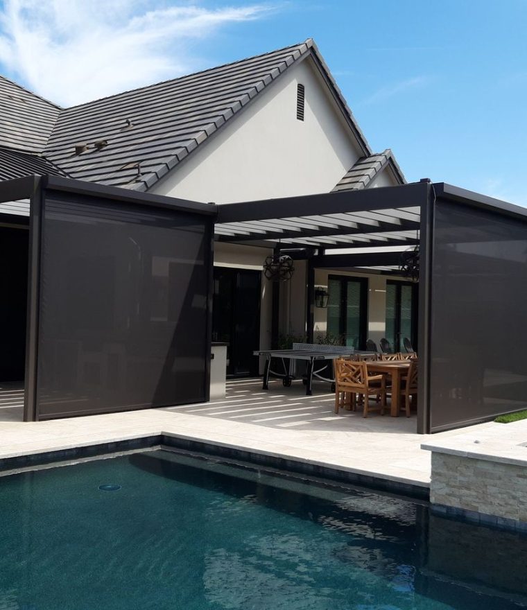 an ourdoor pool patio with a dining and entertaining area screened in with solar mesh.